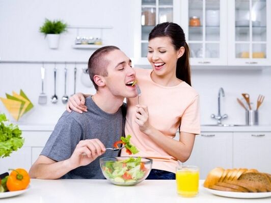 a woman feeds a man with products to naturally increase power